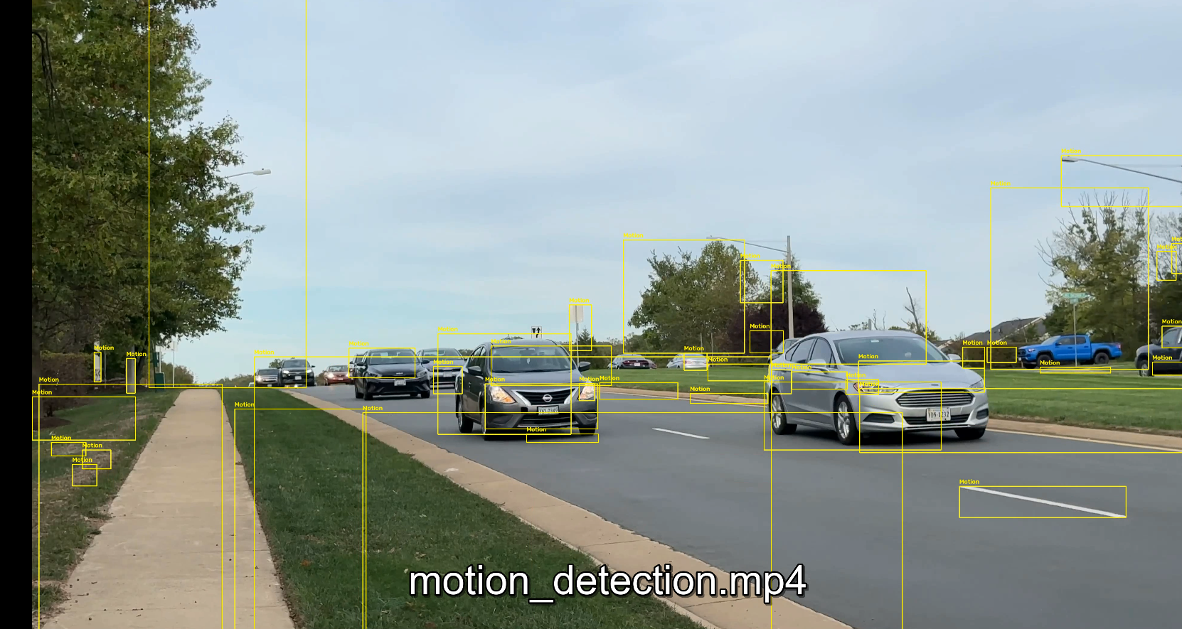 Motion detection output with boxes around moving vehicles on a road